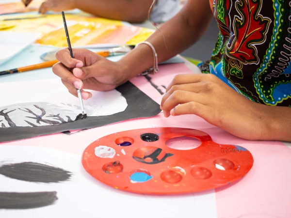 Two students at AKA Dhaka focus on drawing and colouring during an art class.