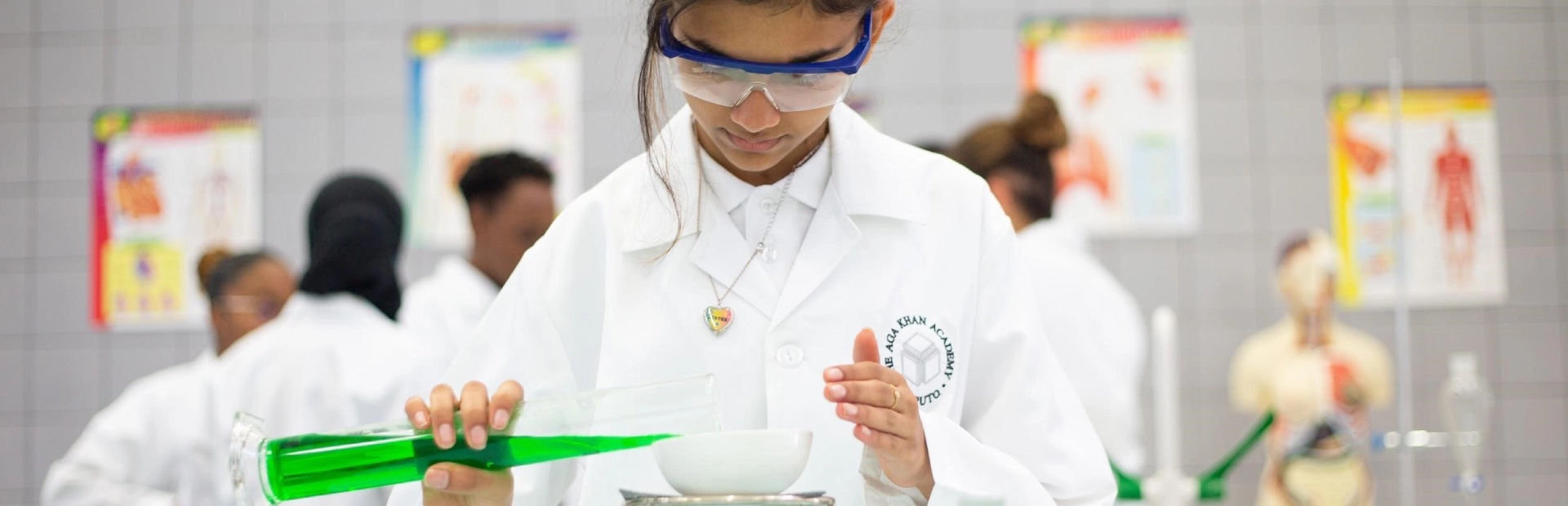 Student participates in a science experiment inside a classroom at AKA Maputo.