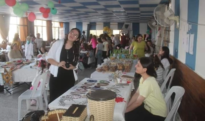 Reem helping filming and helping deaf members in a community outreach programme.