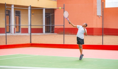 AKA Maputo student playing on the tennis court.