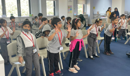 Grade 1 students learning non-verbal communications with a guest speaker