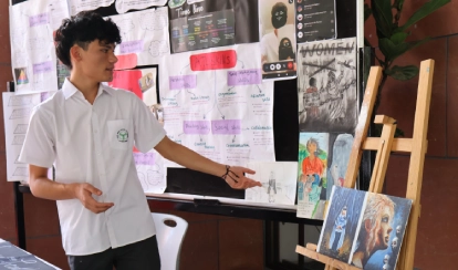 Grade 10 student Rodoshi Tahrin presenting her bicycle-powered generator project at the personal project exhibition.