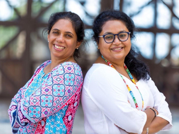 Two students at AKA Dhaka focus on drawing and colouring during an art class.