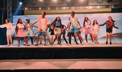 Students performing on a stage.