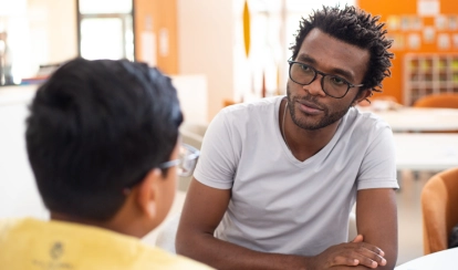 A teacher and student chat at AKA Maputo