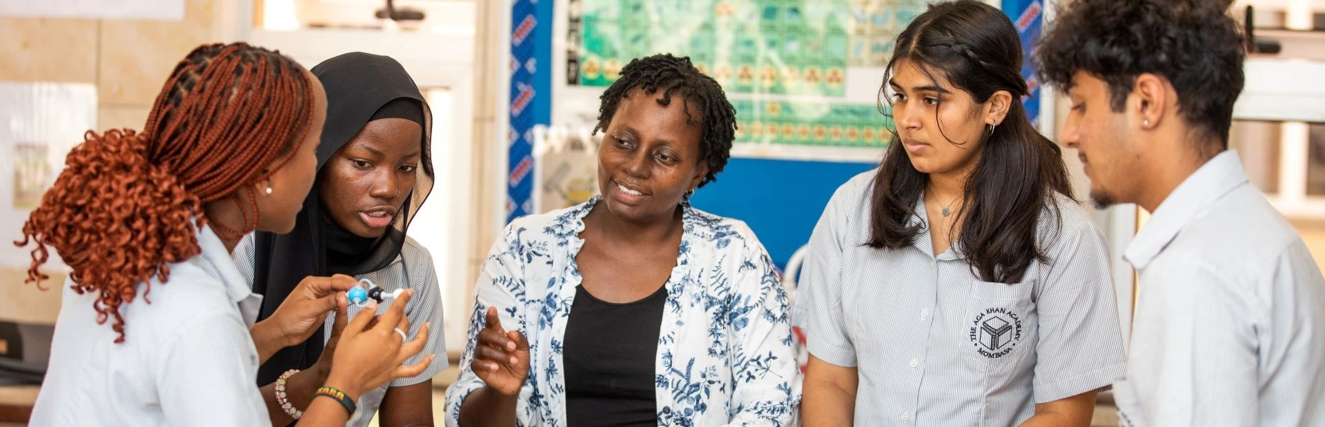 Teacher supporting students during a chemistry lesson